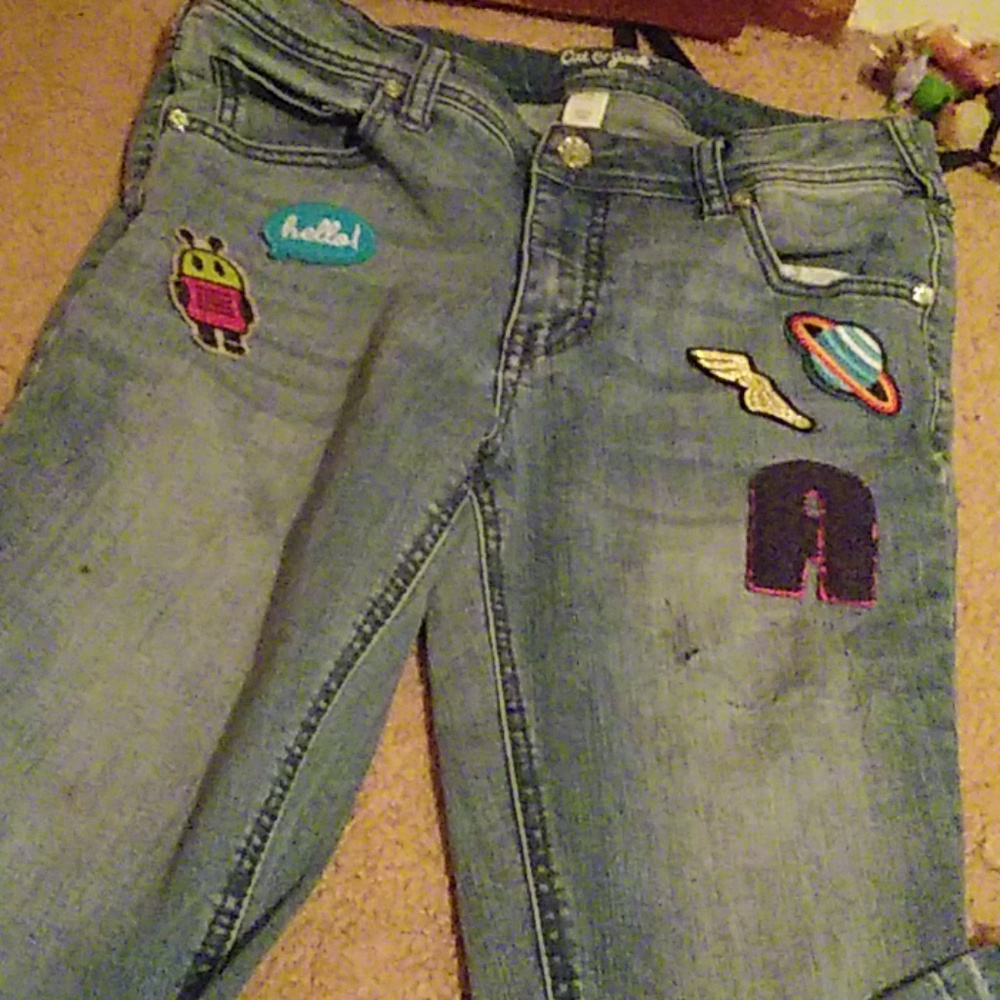 Blue denim jeans with little decorations on them